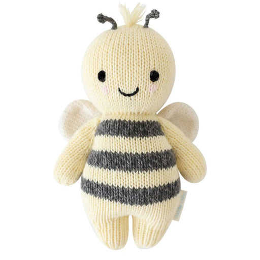 Knitted bee toy with black and white stripes on a white background