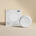 A white Pura Smart Fragrance Diffuser shown next to its white retail box on a warm beige background.