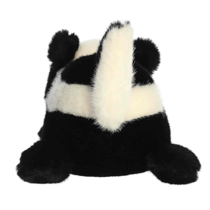 A Skunk plush toy laying flat on a white background
