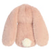 Pink plush bunny toy with a white tail on a white background