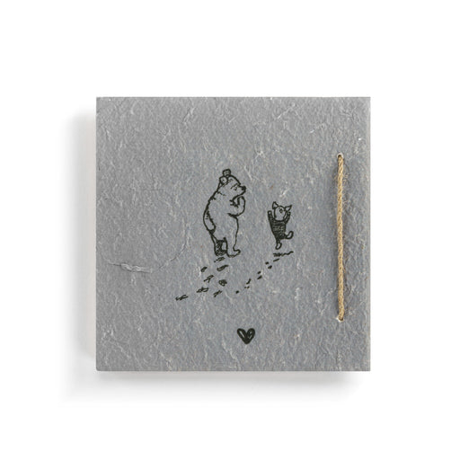 Jewelry card with bear and dog illustration and gold necklace on gray background