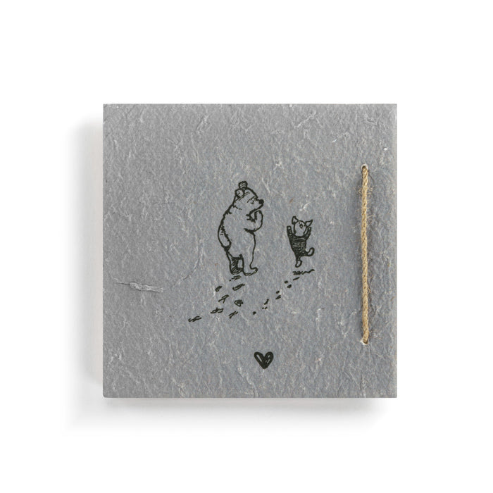 Jewelry card with bear and dog illustration and gold necklace on gray background