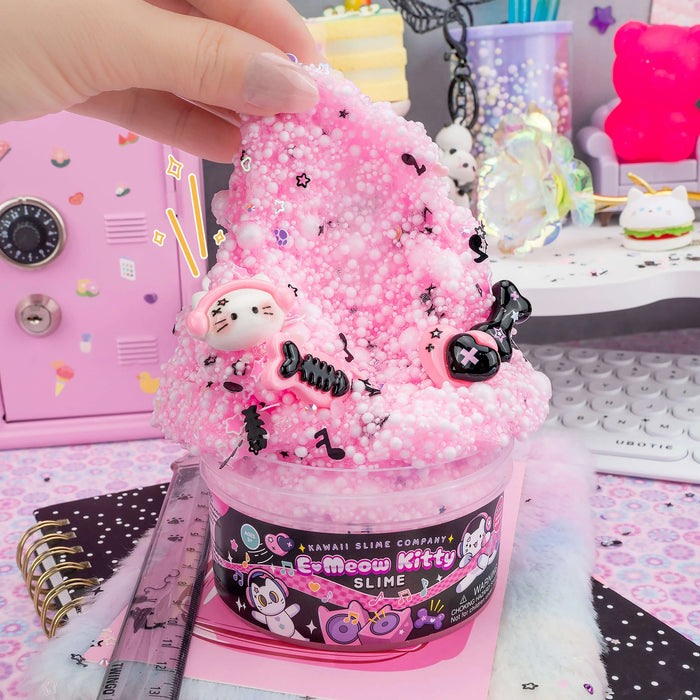 Pink slime product with cat-themed packaging held by a hand on a colorful background