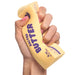 Hand holding a yellow bar of salted butter with purple text on a white background
