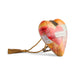 A heart-shaped decorative purse with a plaid pattern in orange, yellow, and red, featuring a red heart in the center, a gold tassel, and a gold rope loop with a metal clasp.