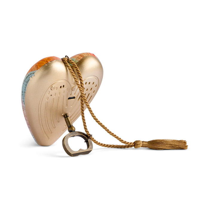 A heart-shaped gold metal bottle opener with a decorative tassel and rope handle, shown on a clean white background.