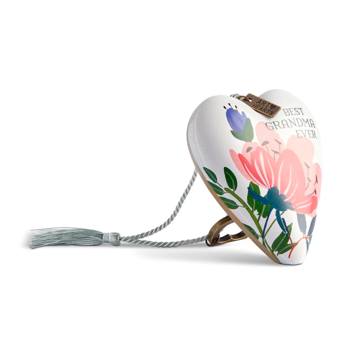 A heart-shaped ceramic keepsake urn with a floral design and the text 'BEST GRANDMA EVER' on a white background.