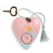 A heart-shaped keepsake box with a pink lid featuring a bicycle illustration and the text 'Daughter, enjoy the ride.' It has a silver rope with a tassel and a brass key, shown on a white background.