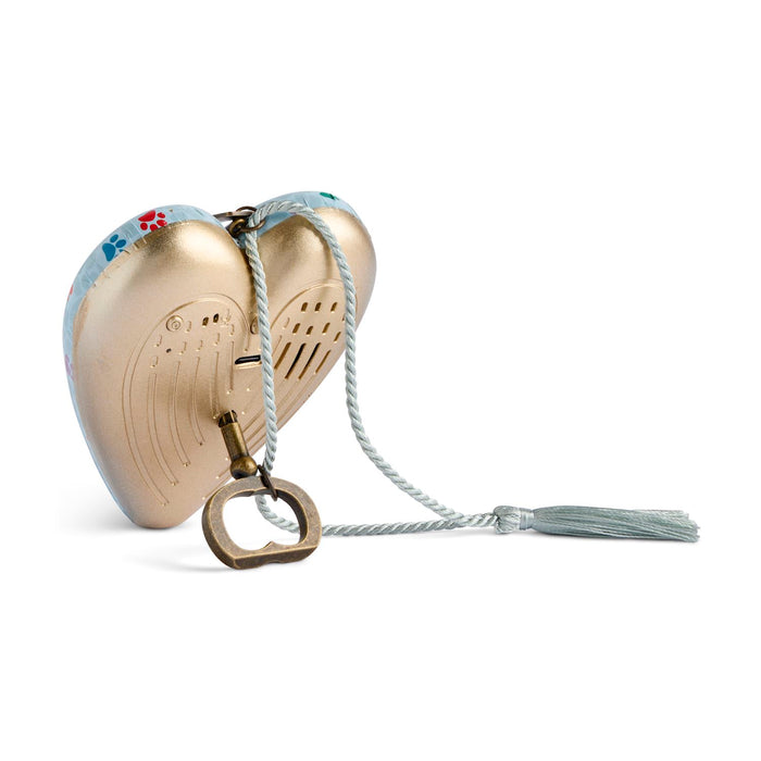 A heart-shaped gold-toned metal keepsake box with a decorative blue and red floral pattern on the lid, a white braided rope, and a brass key ring, shown on a plain white background.