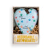 A heart-shaped ceramic pet memorial ornament in a gift box. The ornament is light blue with a white pet-print pattern and colorful paw prints, featuring the text 'tiny paws big blessings'.