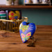 Heart-shaped keychain with butterfly design and 'blue skies ahead' text on a wooden surface.