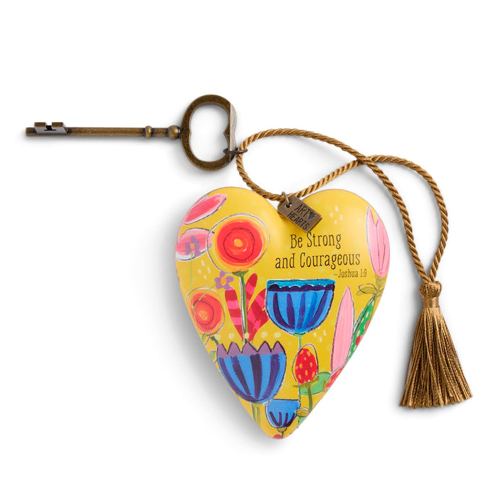 Decorative heart keychain with floral design and motivational quote on a white background