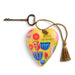 Decorative heart keychain with floral design and motivational quote on a white background
