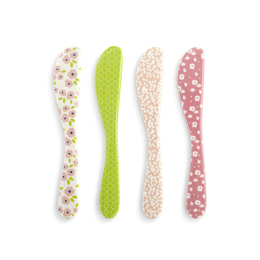 Four floral-patterned spoons on a white background