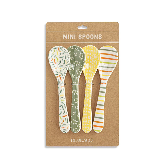 Set of four mini spoons with different patterns on a Demdaco branded packaging.