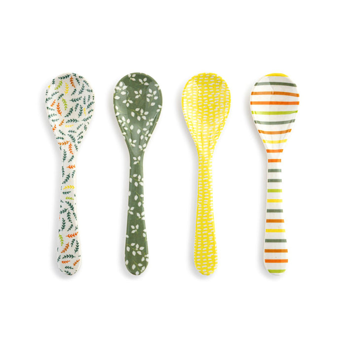 Four patterned spoons on a white background