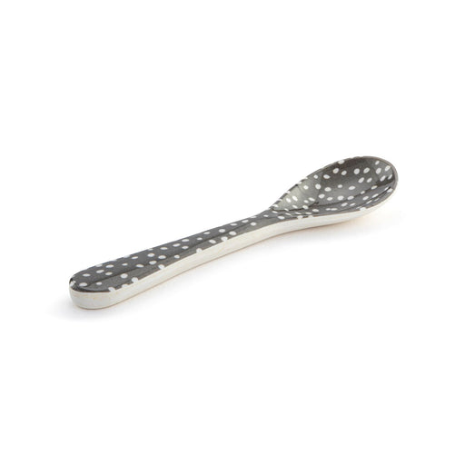 Spoon with gray polka dot pattern on a white background