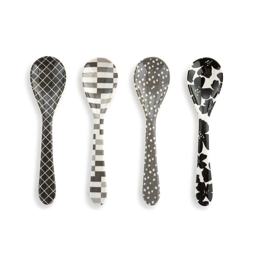 Four patterned spoons on a white background