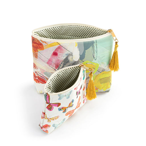 Colorful pouch with floral pattern and gold tassels on a white background