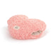 Pink heart-shaped pillow with a label on a white background
