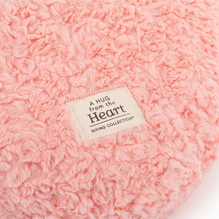 Pink textured blanket with a label reading 'A Hug from the Heart' on a white background