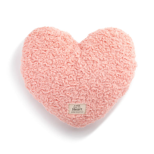 Pink heart-shaped pillow on a white background