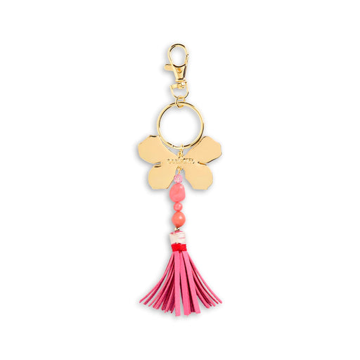 Gold keychain with pink tassel and beads on a white background