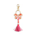 Pink butterfly keychain with tassel on a white background