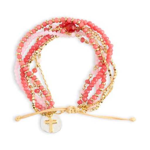 Stack of pink beaded bracelets with gold accents on a white background