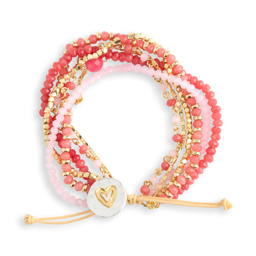 Stack of pink and gold beaded bracelets on a white background