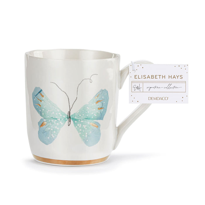 White mug with a blue butterfly design and a tag on a white background