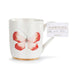 White mug with red butterfly design andDEMdaco packaging on a white background