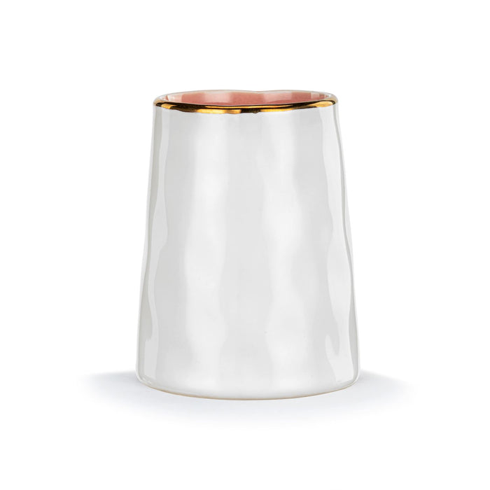 White ceramic tumbler with gold rim on a white background