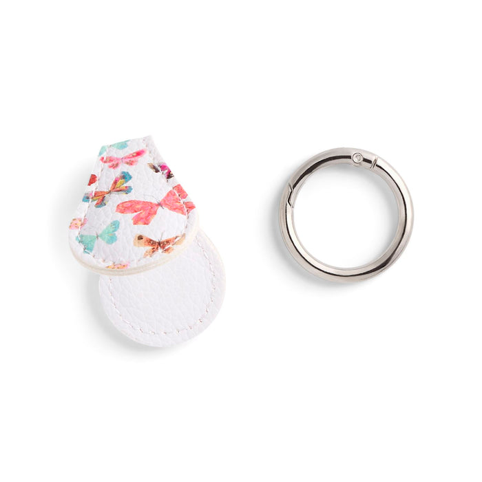 Floral-patterned keychain and silver ring on a white background