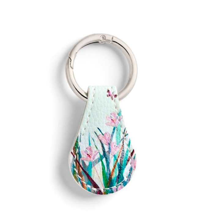 Teardrop-shaped keychain with floral design on a white background