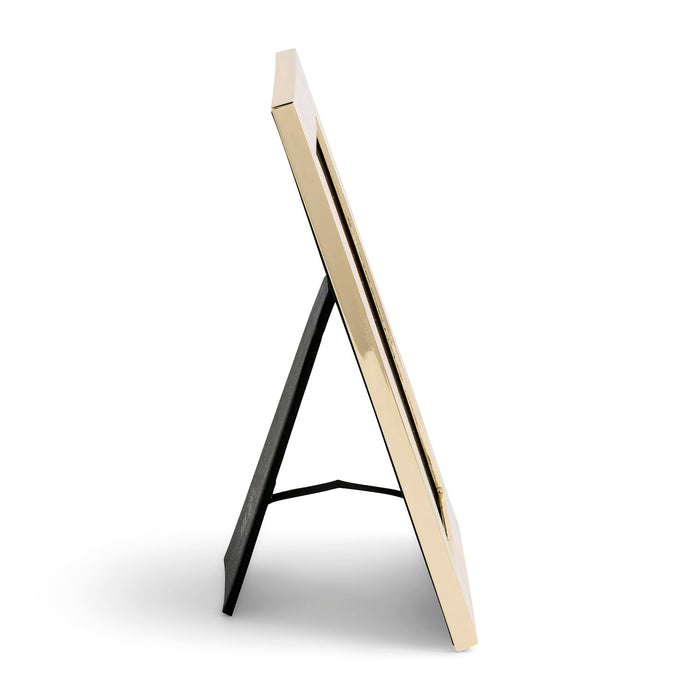 A modern picture frame with a glossy gold finish and a black metal A-frame stand, shown from a side angle on a white background.