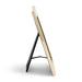 A modern picture frame with a glossy gold finish and a black metal A-frame stand, shown from a side angle on a white background.