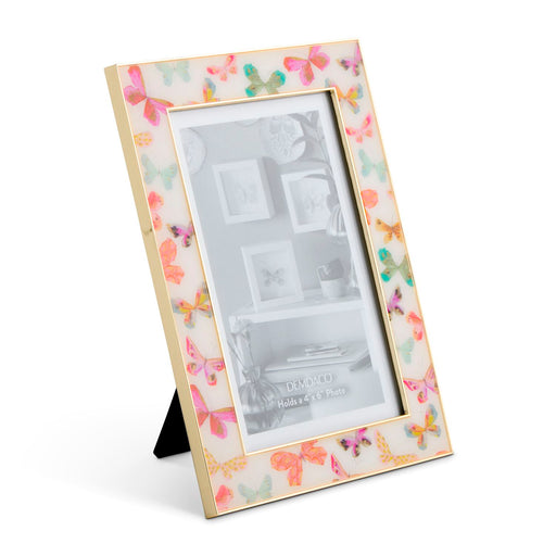 Decorative photo frame with butterfly pattern on a white background