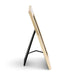 A modern picture frame with a glossy light beige wood or acrylic front and a black metal A-frame stand, shown from a side profile on a white background.