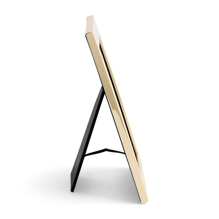 A modern picture frame with a glossy gold-toned border and a black metal A-frame stand, shown from a side profile on a clean white background.