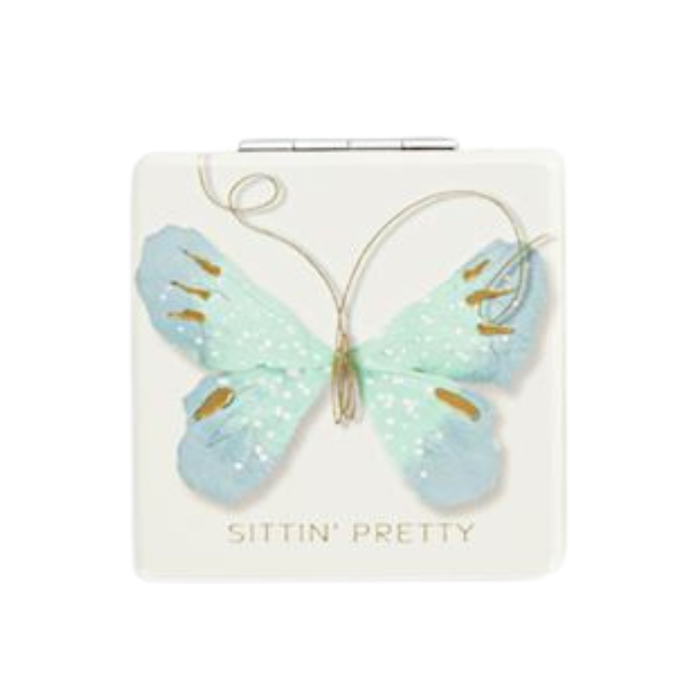 Butterfly-shaped hair clip on a card with 'Sittin' Pretty' text