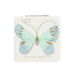 Butterfly-shaped hair clip on a card with 'Sittin' Pretty' text