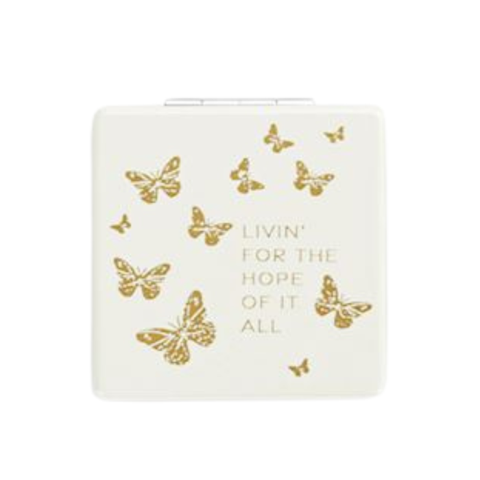 White product with gold butterflies and text on a white background