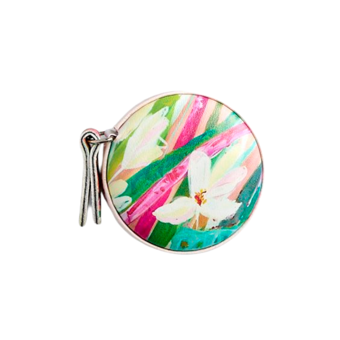 Round compact mirror with floral design on a white background