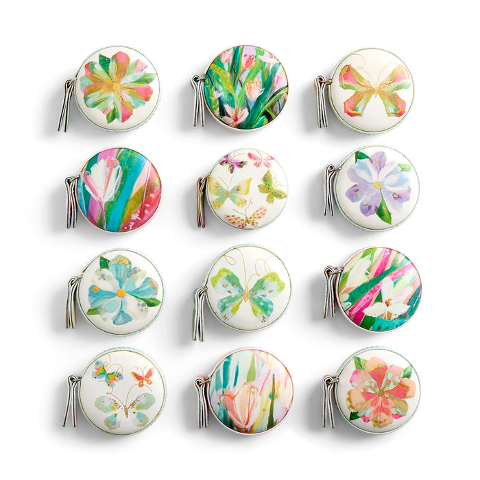 Set of compact mirrors with floral and butterfly designs on a white background