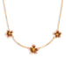 Gold necklace with floral pendants on a white background