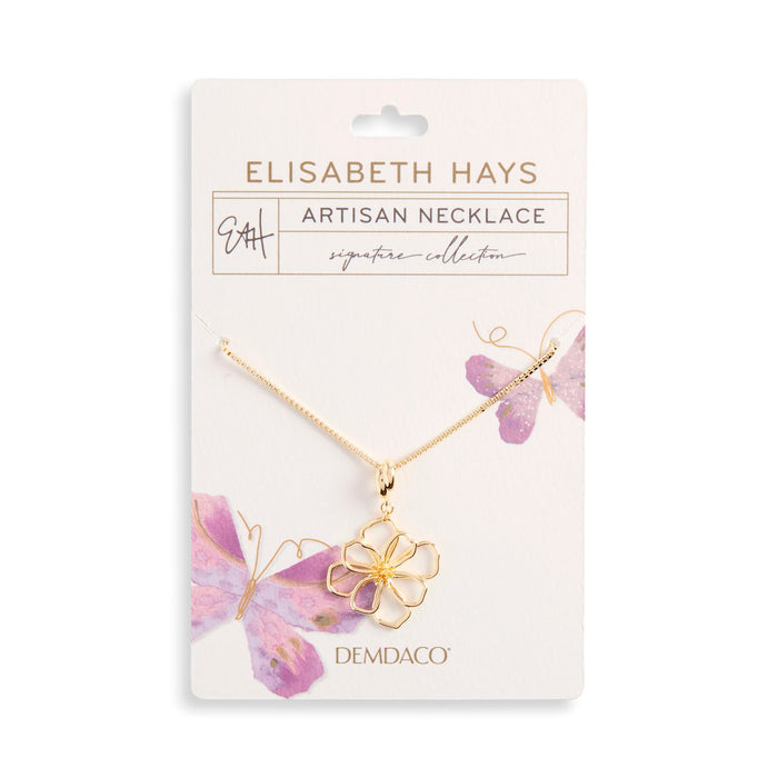 Gold necklace with a floral pendant on a white card featuring 'Elisabeth Hays' branding.