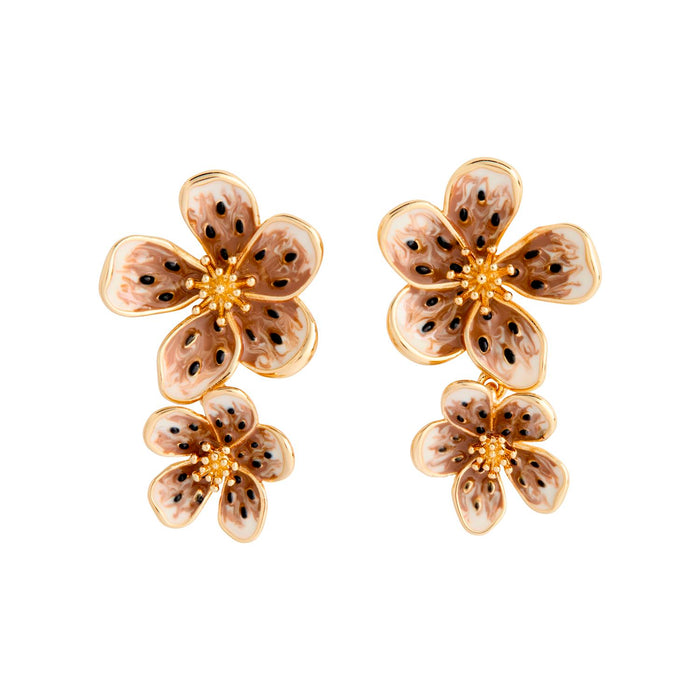 Pair of floral earrings with gold accents on a white background