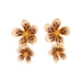 Pair of floral earrings with gold accents on a white background
