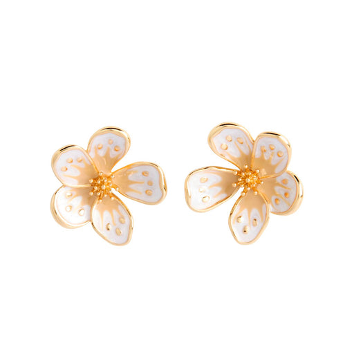 Gold and white flower-shaped earrings on a white background